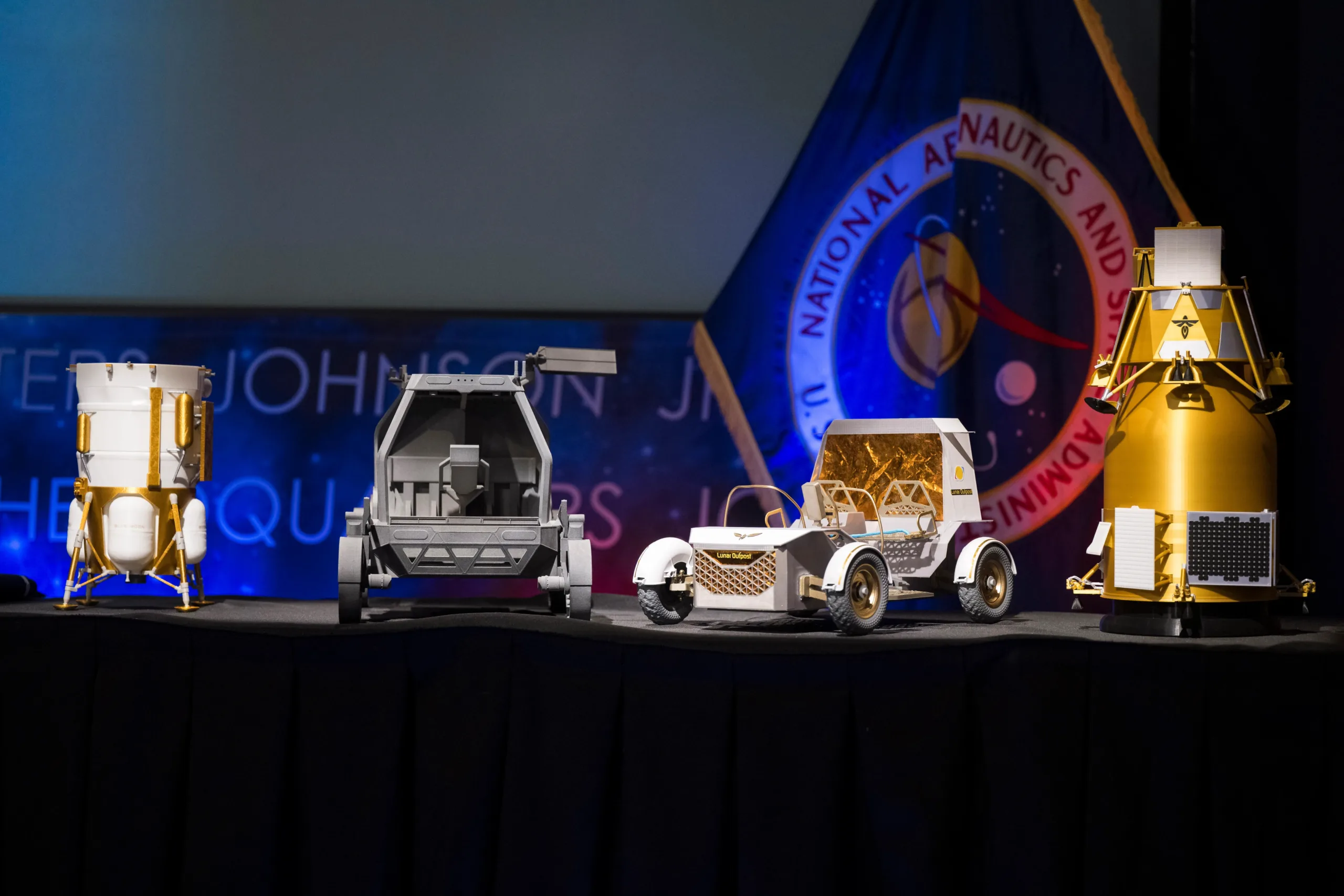 From left to right, models of the Blue Origin Mark 1 Lunar Lander, Astrolab Crewed Lunar Rover, Lunar Outpost Pegasus rover, and the Firely Elytra Dark orbiter